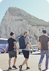 Travelers walking near a mountain